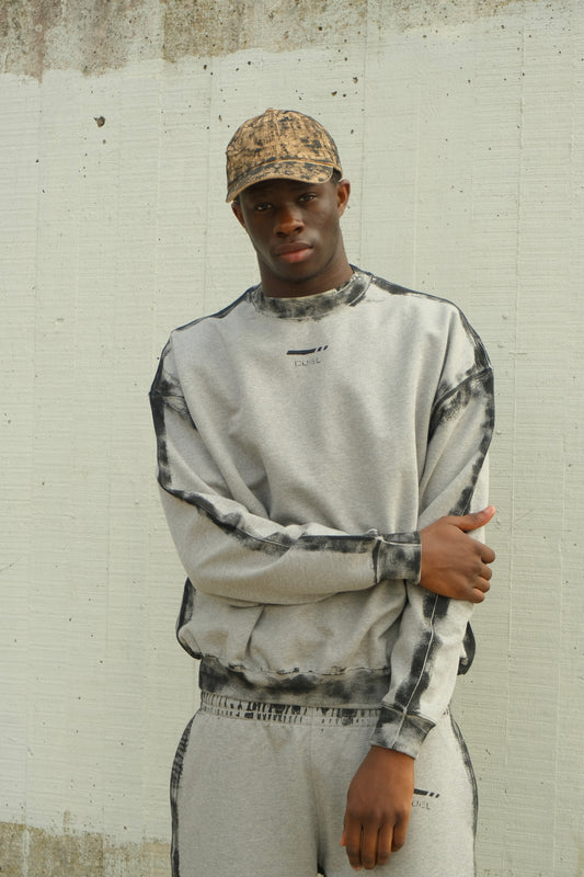 grey crewneck sweatshirt with black spray-painted border